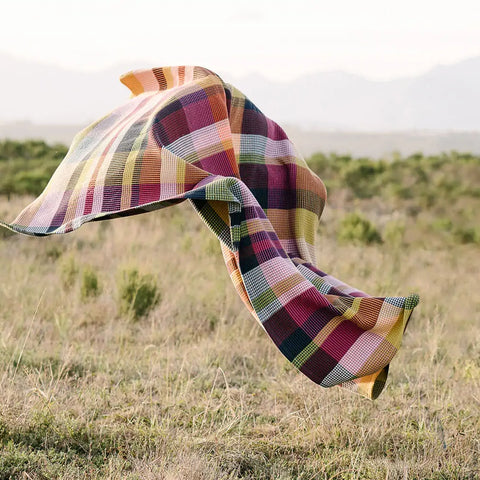 A 100% cotton blanket blowing in a field