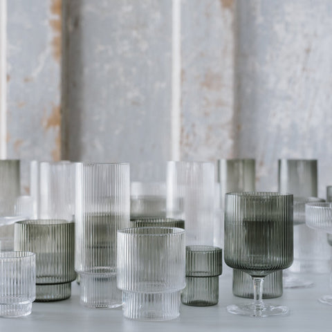 A collection of recycled, tumbler, & stemmed glasses