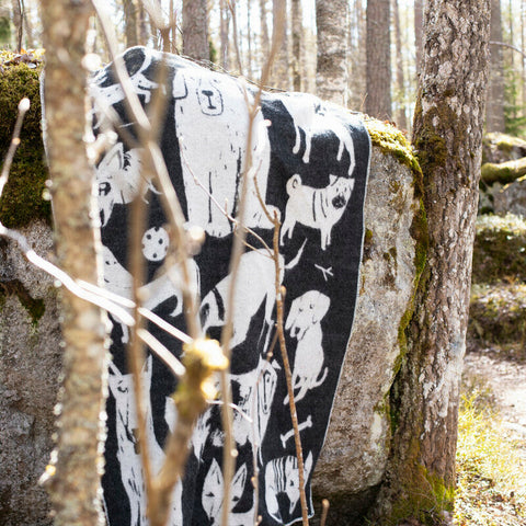 Sustainably-made blanket draped over rock