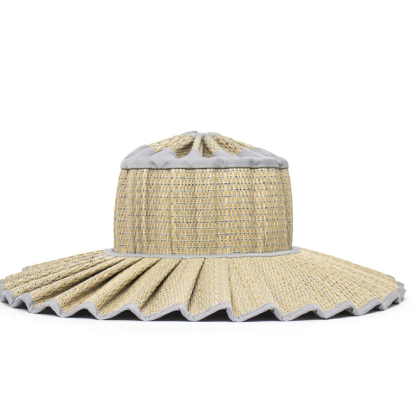 Beige straw hat with scalloped edge on a white background