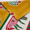 Close-up of a colorful fabric with floral and cactus patterns on a yellow background.