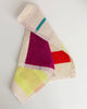 Colorful towel with geometric patterns on a light gray background