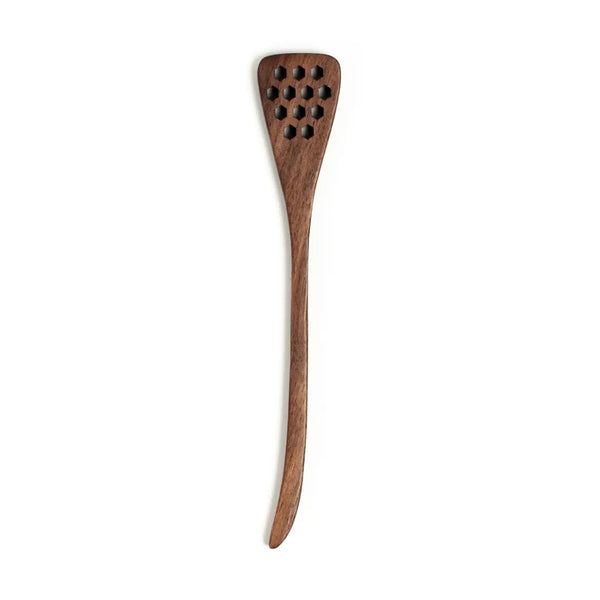 Wooden honey spoon with a unique design on a white background