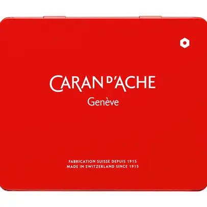A square red metal tin of Caran d'Ache Genève, featuring the brand name in white text and a small white geometric logo in the top right corner, set against a plain white background.
