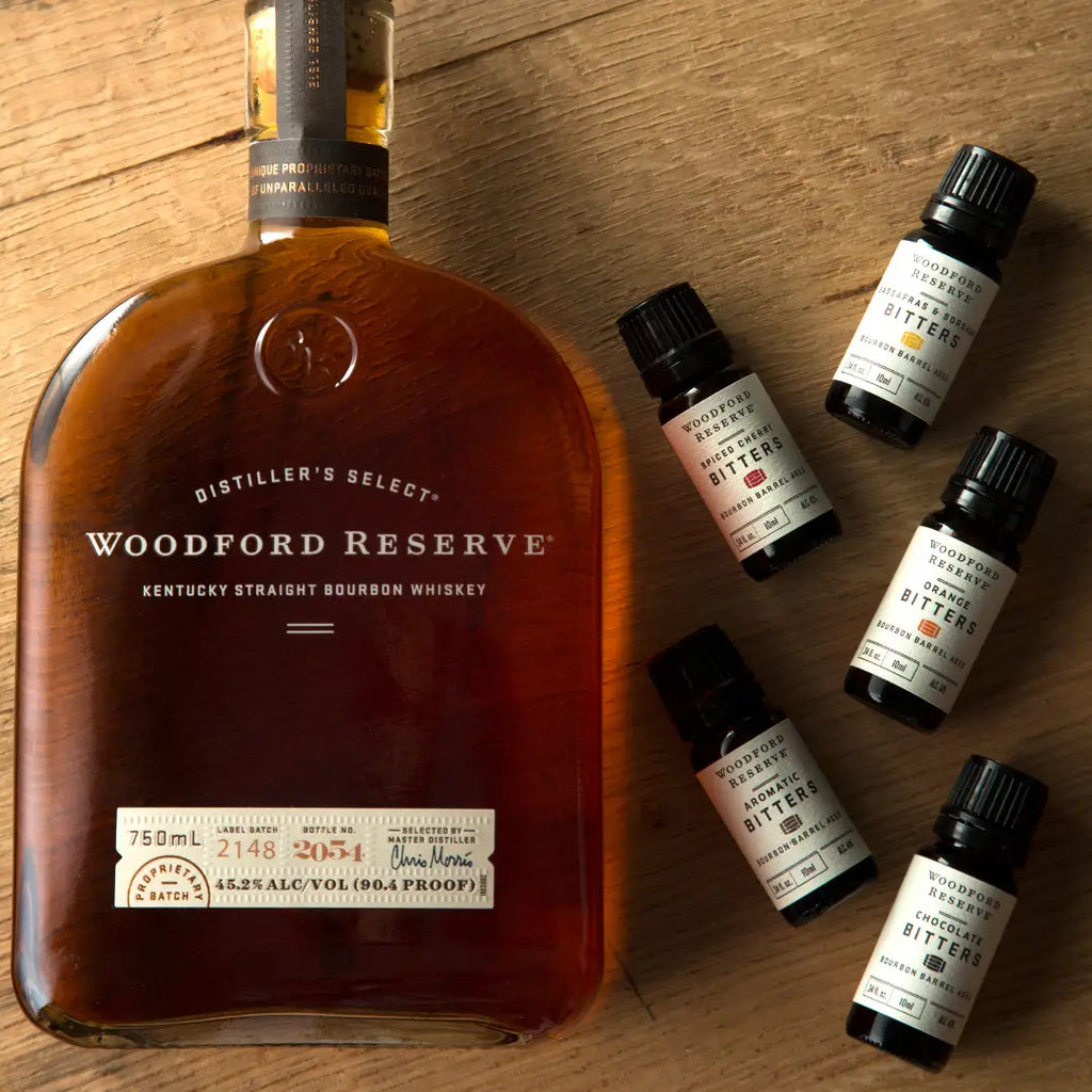 Woodford Reserve bourbon whiskey bottle with bitters on a wooden surface