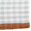 Close-up of a fabric with a checkered pattern transitioning to a solid color.
