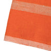 Close-up of an orange fabric with a textured pattern on a white background