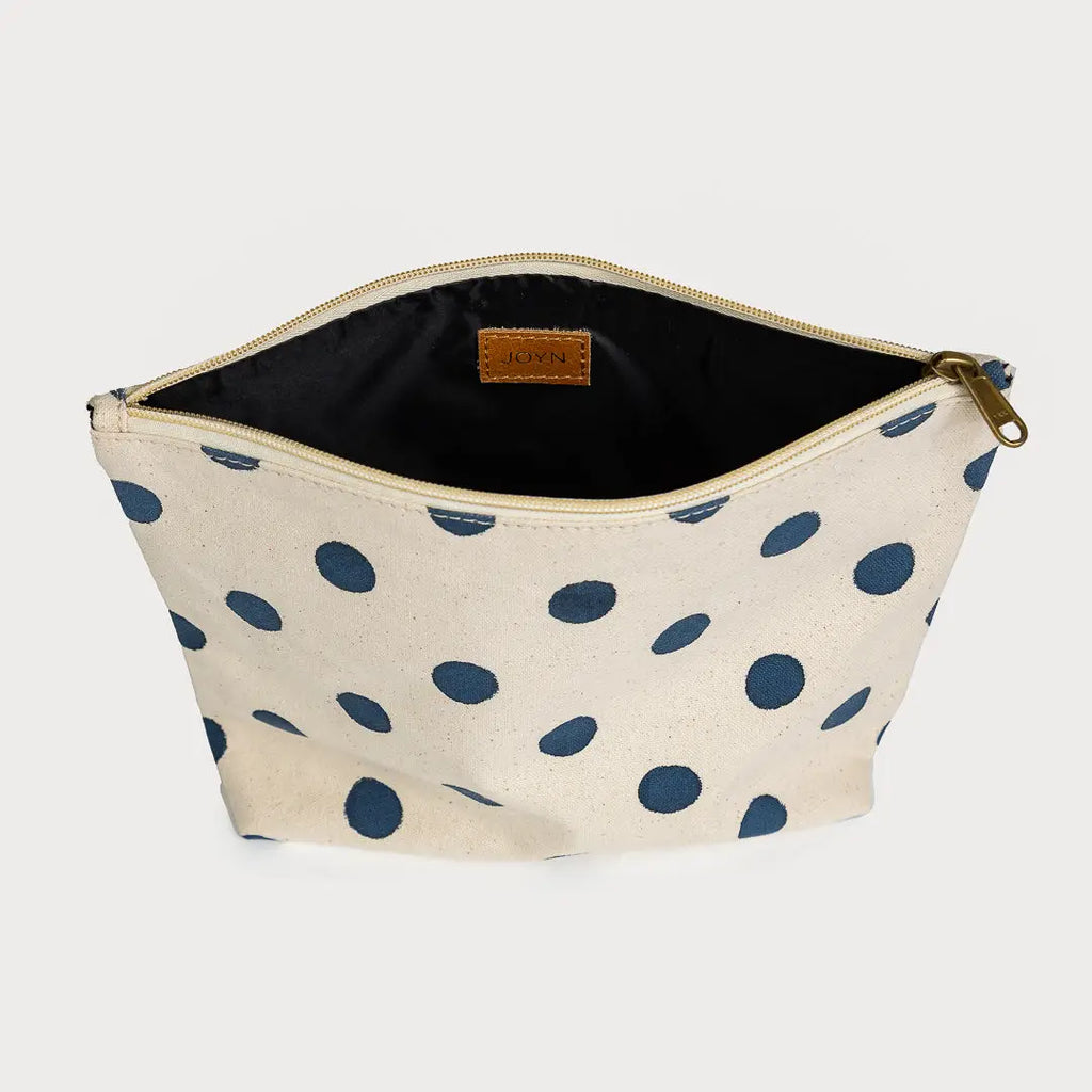 Beige pouch with blue polka dots on a white background