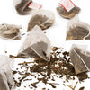 Tea bags with loose tea leaves on a white background