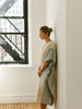 Woman standing by a window in an urban setting