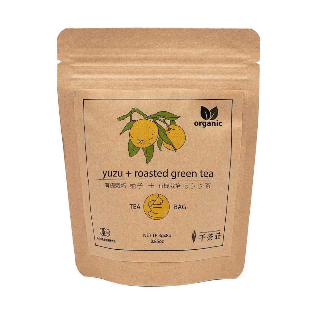 Kraft paper tea bag packaging with yuzu and roasted green tea label on a white background