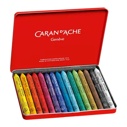 An open red Caran d'Ache Geneva crayon box showing a full set of 15 colored pastels in various colors, arranged neatly in a gray foam-lined tray.