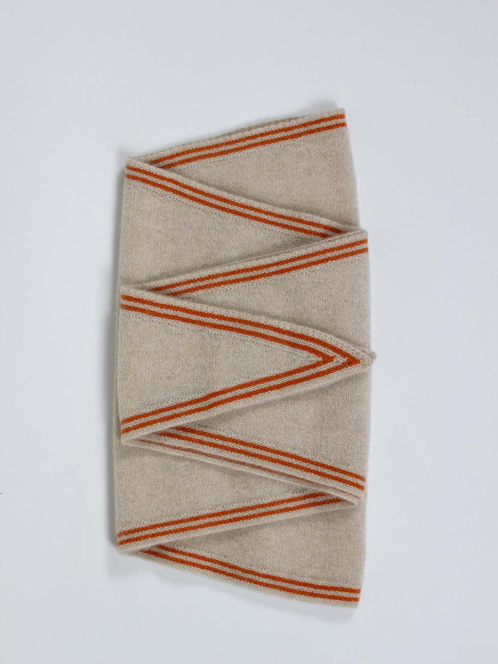 A folded beige wool scarf with orange stripes, displayed on a clean white background.