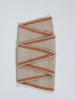 A folded beige wool scarf with orange stripes, displayed on a clean white background.