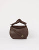 Brown leather handbag with a knot detail on a white background