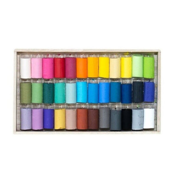Set of colorful pastels in a wooden box on a white background