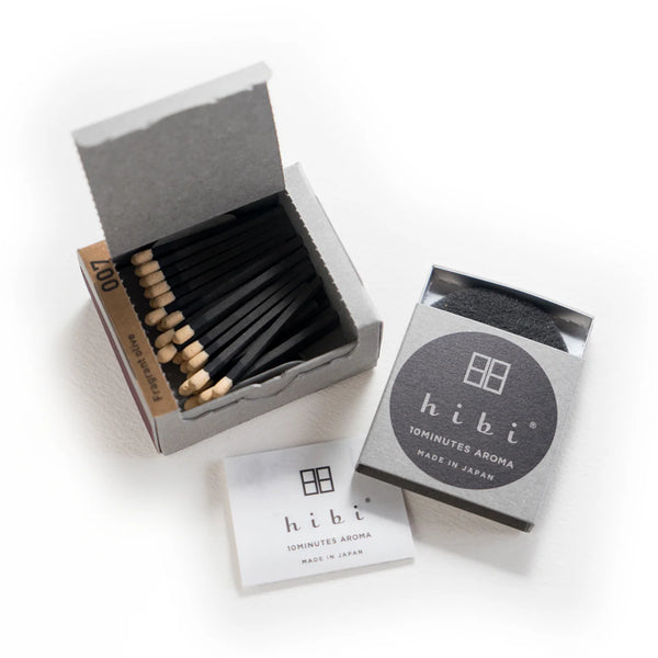 Matchbox with matches and 'hibi' packaging on a white background