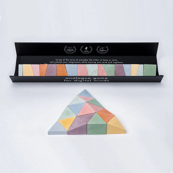Colorful geometric puzzle in front of an open box with text on a white background