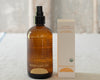 Brown bottle and box of 'Everyday Oil' on a textured surface
