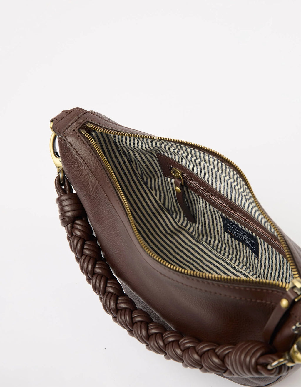 Brown leather handbag with braided handle on a white background