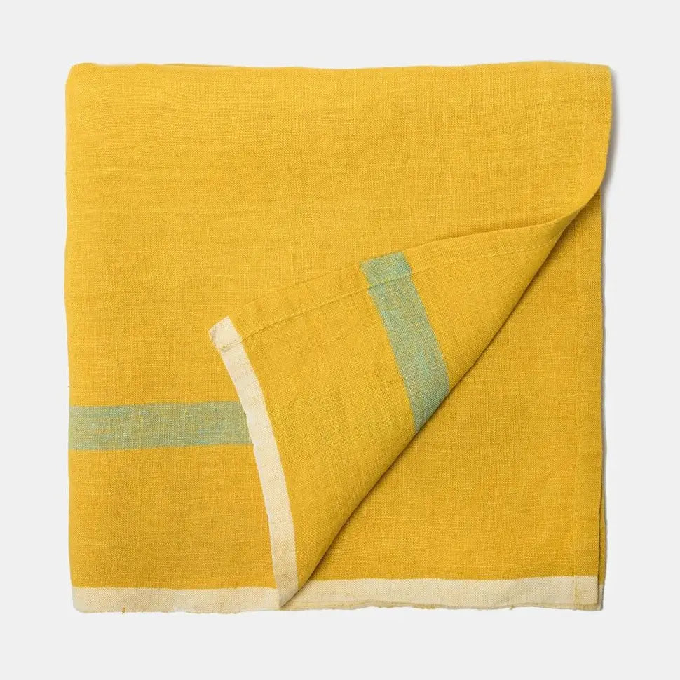 Yellow fabric with green and beige border on a white background
