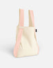 Beige tote bag with pink straps on a light gray background