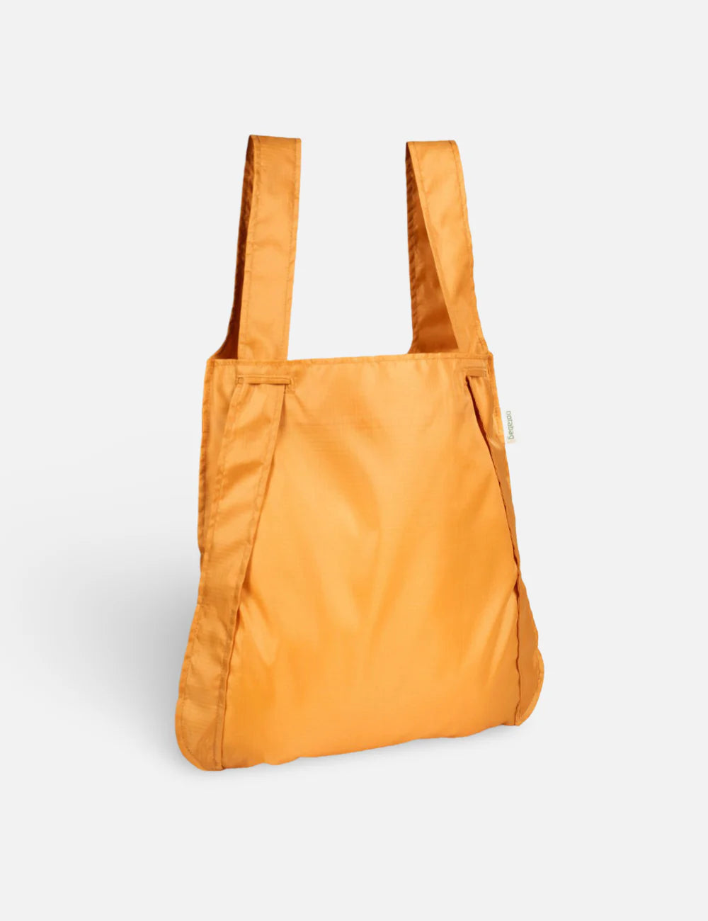 Orange tote bag on a light gray background