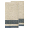 Two folded woven towels in a natural beige color with a herringbone pattern and a navy blue striped border near the bottom, shown on a plain white background.