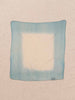 Blue and white square fabric swatch on a beige background