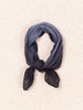 Navy blue scarf tied into a knot on a beige background