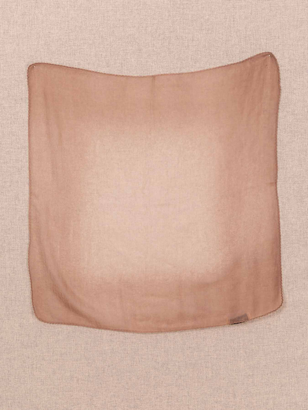 Brown cashmere scard on a beige background