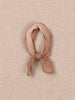 Pink knotted scarf on a beige textured background.