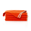 Stack of orange towels on a white background
