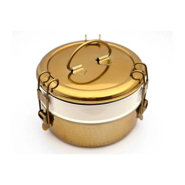 Gold and silver two-tiered container on a white background