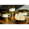 Brass lunch boxes with white interiors on a wooden surface, accompanied by naan bread.