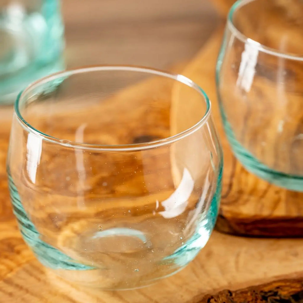 Clear glass tumblers on a wooden surface