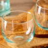 Clear glass tumblers on a wooden surface