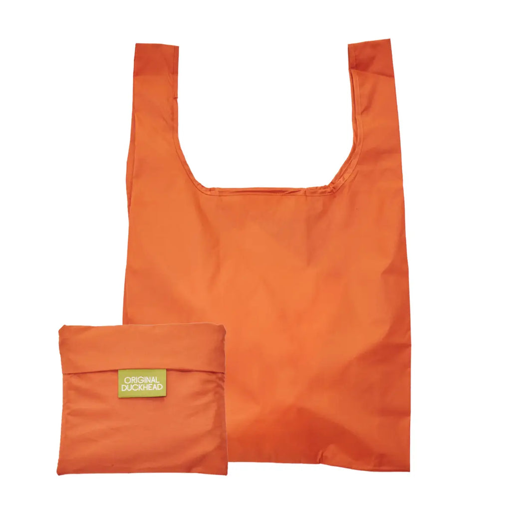 An orange reusable shopping bag shown partially folded, with a small yellow-green brand patch reading Original Duckhead on the folded section, against a plain white background.