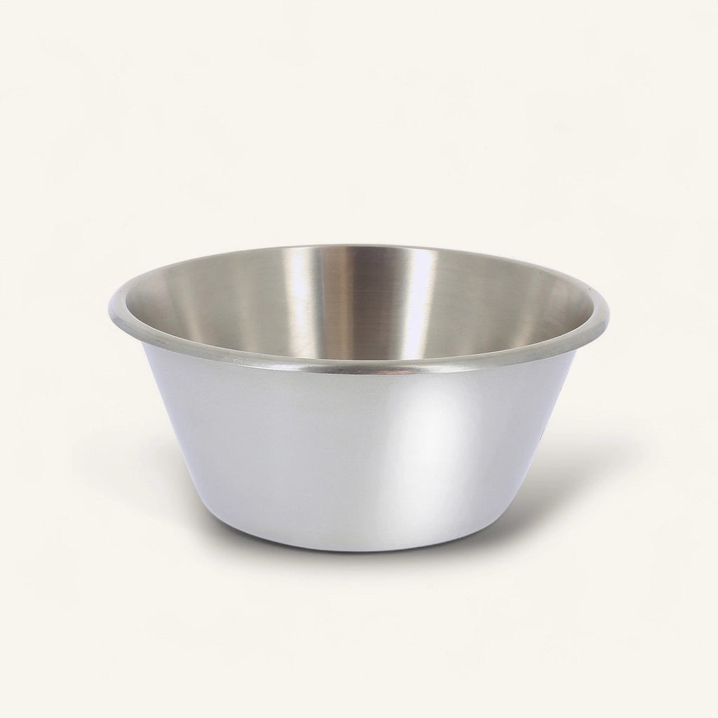 A stainless steel mixing bowl with a brushed metal finish, photographed on a clean, solid off-white background.