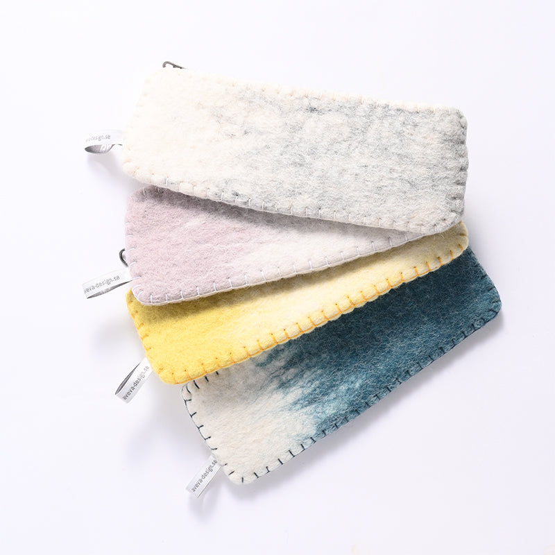 Four fabric pouches in different colors on a white background