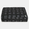 Black pet bed with white line pattern on a white background