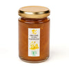Jar of organic yuzu marmalade with a gold lid on a white background