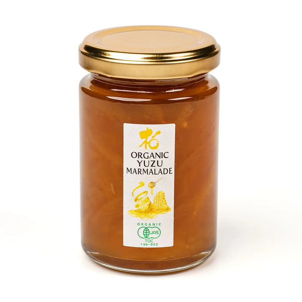 Jar of organic yuzu marmalade with a gold lid on a white background