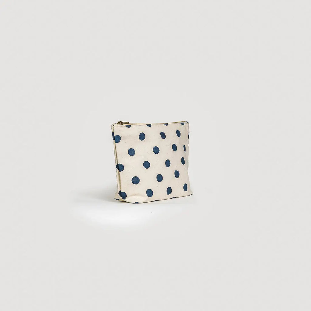 Small pouch with blue polka dots on a light gray background