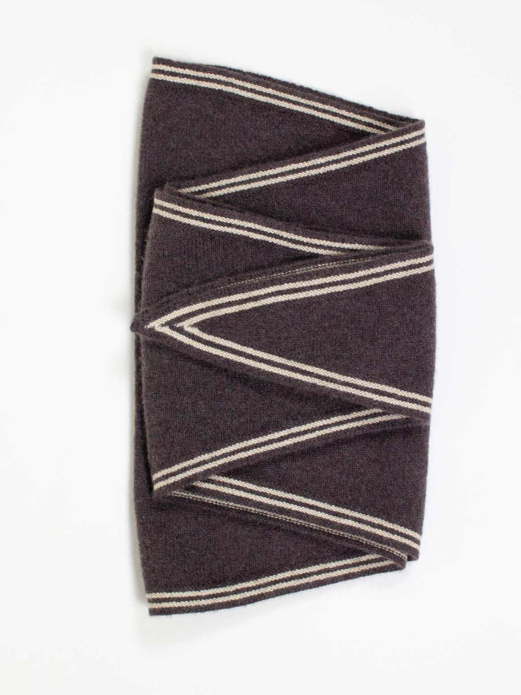 Folded brown fabric with beige stripes on a white background