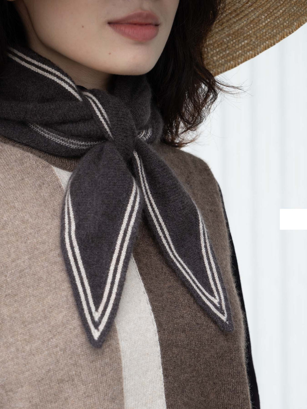 Person wearing a scarf with a striped pattern