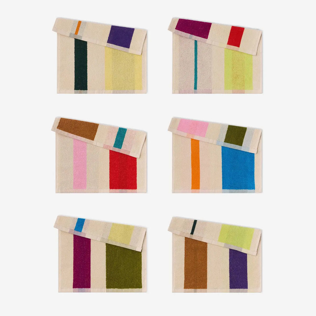 Set of six colorful striped towels on a white background