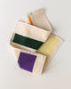 Colorful towels with geometric patterns on a light gray background