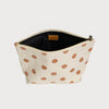 Beige pouch with brown polka dots on a light gray background