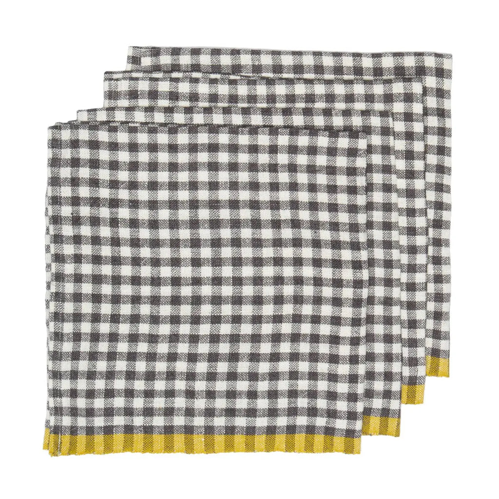 Three folded checkered napkins with a black and white gingham pattern and a yellow striped border, arranged in a stack on a white background.